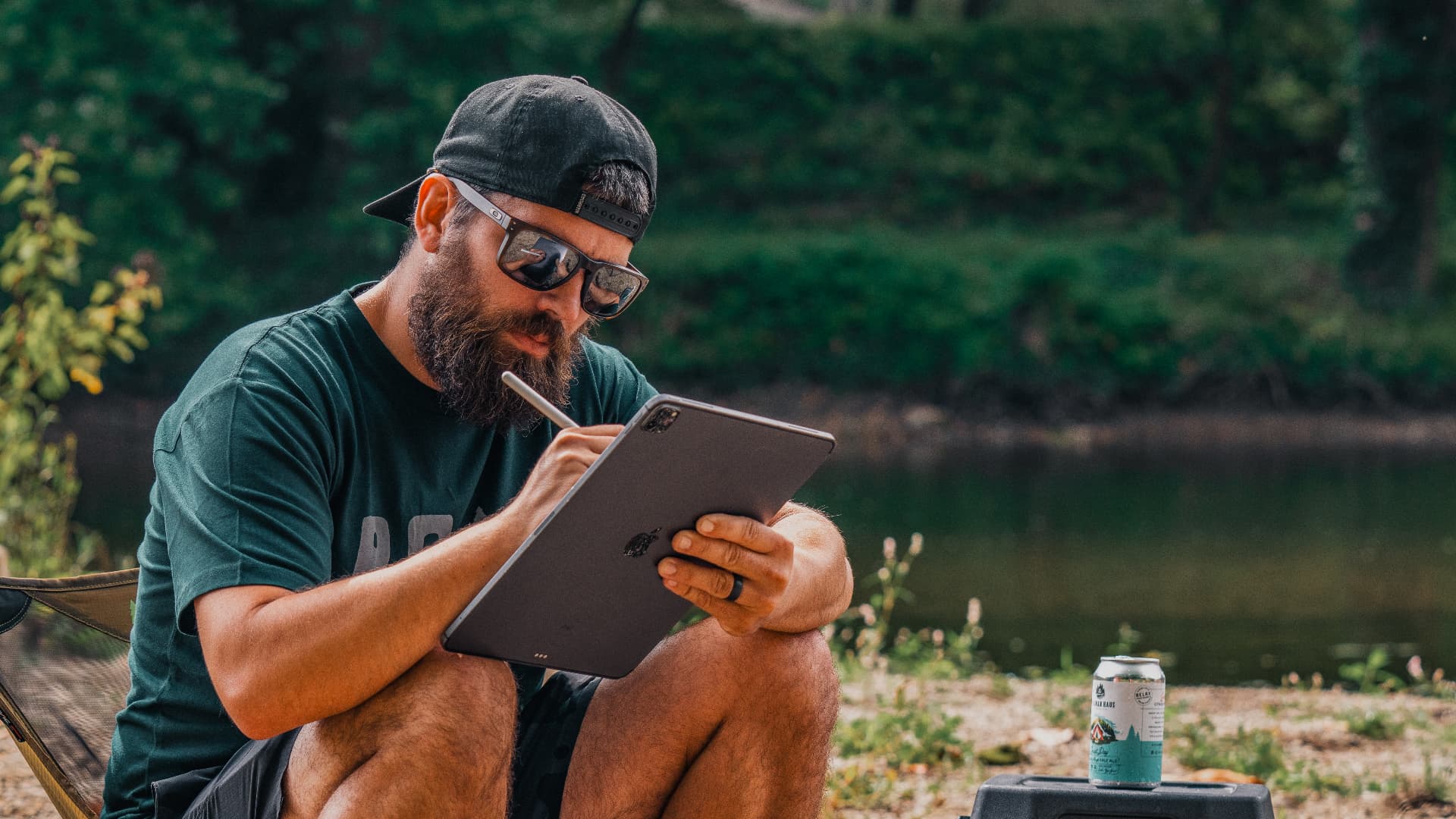 Heeler Creative founder sketching on a tablet in the field
